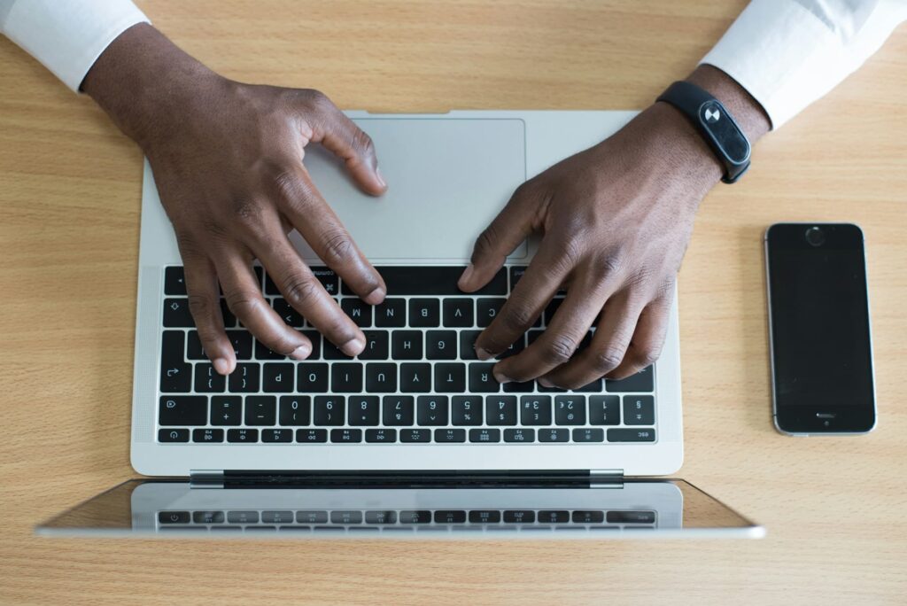 A man learning an online course on an Apple mac laptop